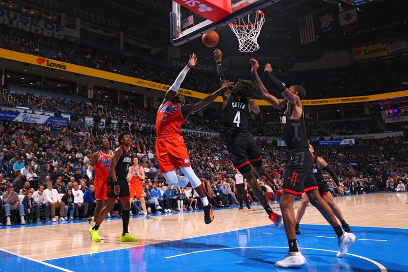 OKLAHOMA CITY, OK - MARCH 27:  Luguentz Dort #5 of the Oklahoma City Thunder and Jalen Green #4 of the Houston Rockets battle for a rebound on March 27, 2024 at Paycom Arena in Oklahoma City, Oklahoma. NOTE TO USER: User expressly acknowledges and agrees that, by downloading and or using this photograph, User is consenting to the terms and conditions of the Getty Images License Agreement. Mandatory Copyright Notice: Copyright 2024 NBAE (Photo by Zach Beeker/NBAE via Getty Images)