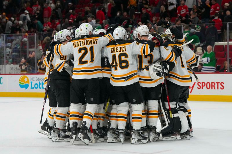 Mar 26, 2023; Raleigh, North Carolina, USA;  Boston Bruins players celebrate their victory against the Carolina Hurricanes at PNC Arena. Mandatory Credit: James Guillory-USA TODAY Sports