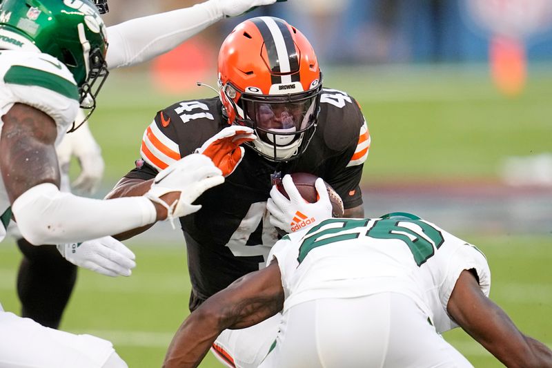 Cleveland Browns running back John Kelly Jr. (41) is tackled by New York Jets cornerback Brandin Echols (26) during the first half of the NFL exhibition Hall of Fame football game, Thursday, Aug. 3, 2023, in Canton, Ohio. (AP Photo/Sue Ogrocki)