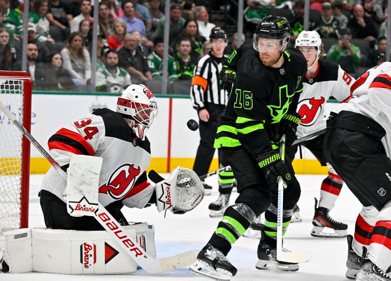 Mar 14, 2024; Dallas, Texas, USA; New Jersey Devils goaltender Jake Allen (34) and Dallas Stars center Joe Pavelski (16) track the puck in the air during the second period at the American Airlines Center. Mandatory Credit: Jerome Miron-USA TODAY Sports