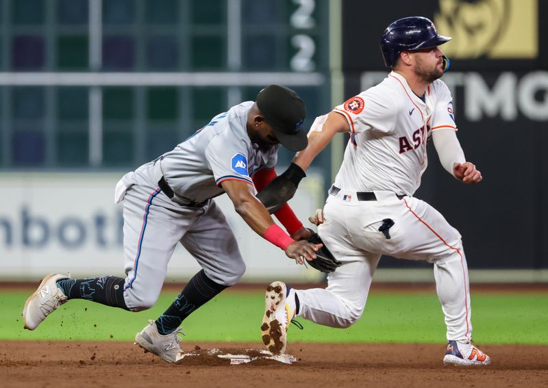 Jul 9, 2024; Houston, Texas, USA;  Houston Astros right fielder Chas McCormick (20) steals second base against Miami Marlins second baseman Vidal Brujan (17) in the fifth inning at Minute Maid Park. Mandatory Credit: Thomas Shea-USA TODAY Sports