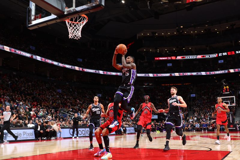 TORONTO, CANADA - MARCH 20: Davion Mitchell #15 of the Sacramento Kings drives to the basket during the game against the Toronto Raptors on March 20, 2024 at the Scotiabank Arena in Toronto, Ontario, Canada.  NOTE TO USER: User expressly acknowledges and agrees that, by downloading and or using this Photograph, user is consenting to the terms and conditions of the Getty Images License Agreement.  Mandatory Copyright Notice: Copyright 2024 NBAE (Photo by Vaughn Ridley/NBAE via Getty Images)