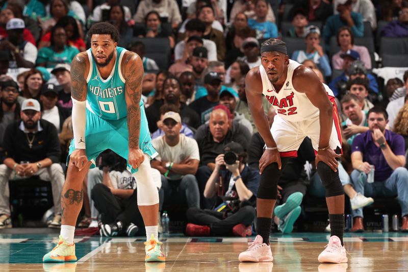 CHARLOTTE, NC - October 26: Miles Bridges #0 of the Charlotte Hornets and Jimmy Butler #22 of the Miami Heat  looks on during the game during the Miami Heat vs Charlotte Hornets game on October 26, 2024 at Spectrum Center in Charlotte, North Carolina. NOTE TO USER: User expressly acknowledges and agrees that, by downloading and or using this photograph, User is consenting to the terms and conditions of the Getty Images License Agreement. Mandatory Copyright Notice: Copyright 2024 NBAE (Photo by Kent Smith/NBAE via Getty Images)