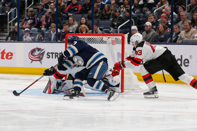 Jan 19, 2024; Columbus, Ohio, USA; Columbus Blue Jackets right wing Justin Danforth (17) shoots as New Jersey Devils defenseman Luke Hughes (43) trails the play during the third period at Nationwide Arena. Mandatory Credit: Russell LaBounty-USA TODAY Sports