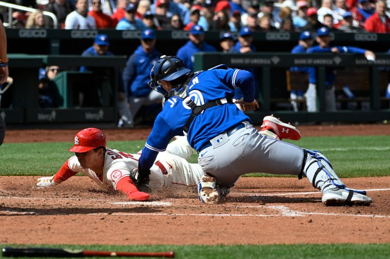 Apr 1, 2023; St. Louis, Missouri, USA; St. Louis Cardinals designated hitter Nolan Gorman (16) is tagged out by Toronto Blue Jays catcher Danny Jansen (9) in the sixth inning at Busch Stadium. Mandatory Credit: Joe Puetz-USA TODAY Sports