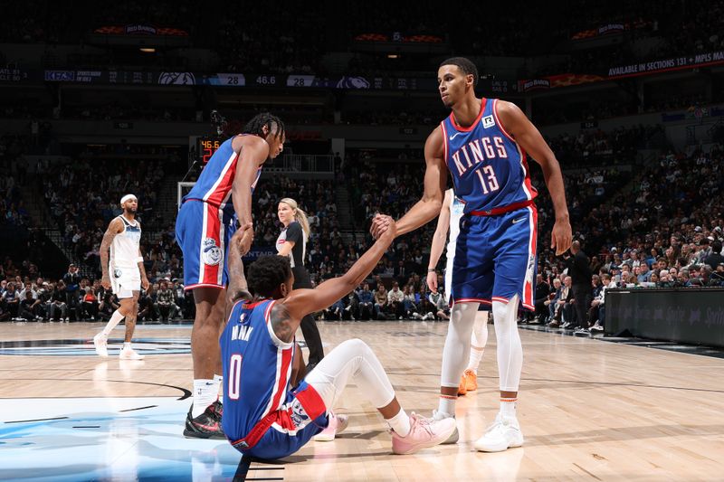 MINNEAPOLIS, MN -  NOVEMBER 27: Issac Jones #17 and Keegan Murray #13 help teammate Malik Monk #0 of the Sacramento Kings off the floor during the game against the Minnesota Timberwolves on November 27, 2024 at Target Center in Minneapolis, Minnesota. NOTE TO USER: User expressly acknowledges and agrees that, by downloading and or using this Photograph, user is consenting to the terms and conditions of the Getty Images License Agreement. Mandatory Copyright Notice: Copyright 2024 NBAE (Photo by David Sherman/NBAE via Getty Images)