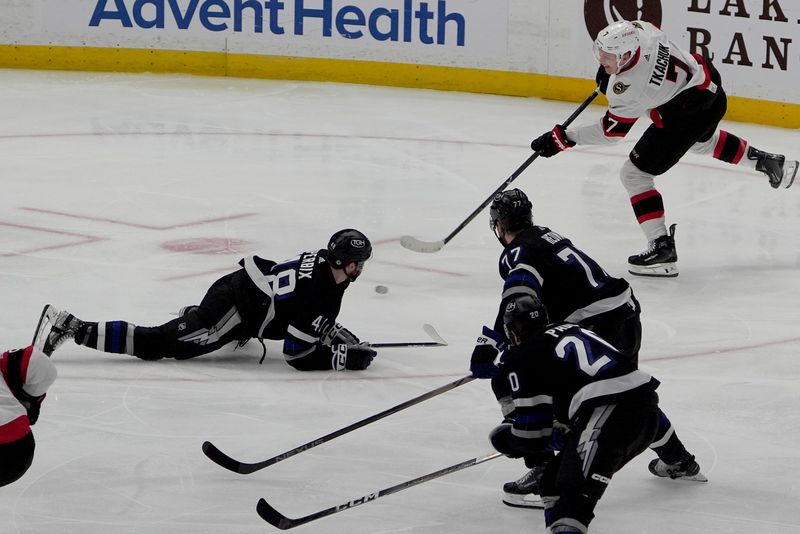 Feb 19, 2024; Tampa, Florida, USA; Ottawa Senators left wing Brady Tkachuk (7) moves the puck past Tampa Bay Lightning players during the third period at Amalie Arena. Mandatory Credit: Dave Nelson-USA TODAY Sports