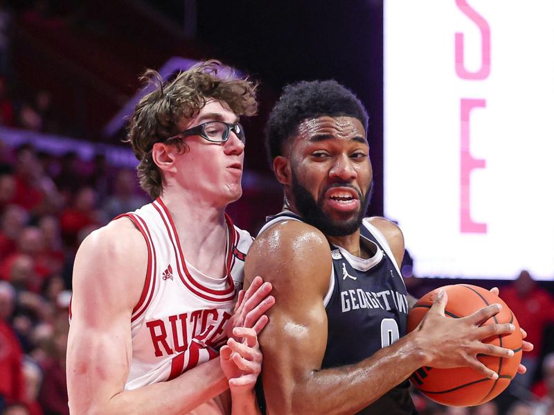 Nov 15, 2023; Piscataway, New Jersey, USA; Georgetown Hoyas guard Dontrez Styles (0) drives to the basket against Rutgers Scarlet Knights guard Gavin Griffiths (10) during the first half at Jersey Mike's Arena. Mandatory Credit: Vincent Carchietta-USA TODAY Sports