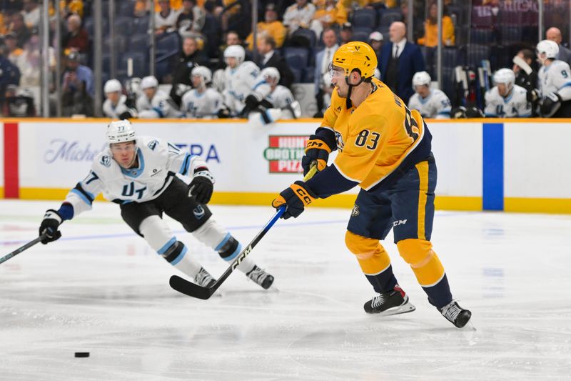 Oct 11, 2025; Nashville, Tennessee, USA;  Nashville Predators defenseman Adam Wilsby (83) passes the puck against the Utah Mammoth during the second period at Bridgestone Arena. Mandatory Credit: Steve Roberts-Imagn Images