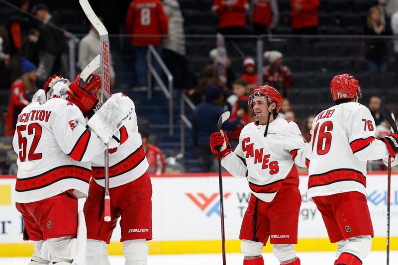 Jan 5, 2024; Washington, District of Columbia, USA; Carolina Hurricanes goaltender Pyotr Kochetkov (52) celebrates with Hurricanes center Jordan Staal (11) after their game against the Washington Capitals at Capital One Arena. Mandatory Credit: Geoff Burke-USA TODAY Sports