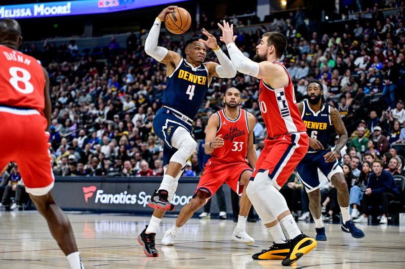 DENVER, COLORADO - DECEMBER 13: Russell Westbrook #4 of the Denver Nuggets is defended by Ivica Zubac #40 of the LA Clippers in the first half at Ball Arena on December 13, 2024, 2024 in Denver, Colorado. NOTE TO USER: User expressly acknowledges and agrees that, by downloading and or using this photograph, User is consenting to the terms and conditions of the Getty Images License Agreement. (Photo by Dustin Bradford/Getty Images)