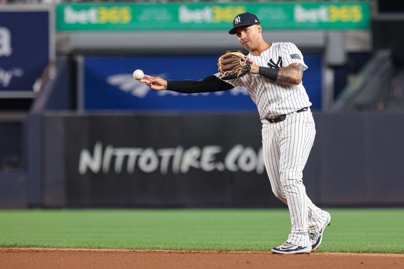 Aug 30, 2024; Bronx, New York, USA; New York Yankees second baseman Gleyber Torres (25) throws the ball to first base for an out during the third inning against the St. Louis Cardinals at Yankee Stadium. Mandatory Credit: Vincent Carchietta-USA TODAY Sports