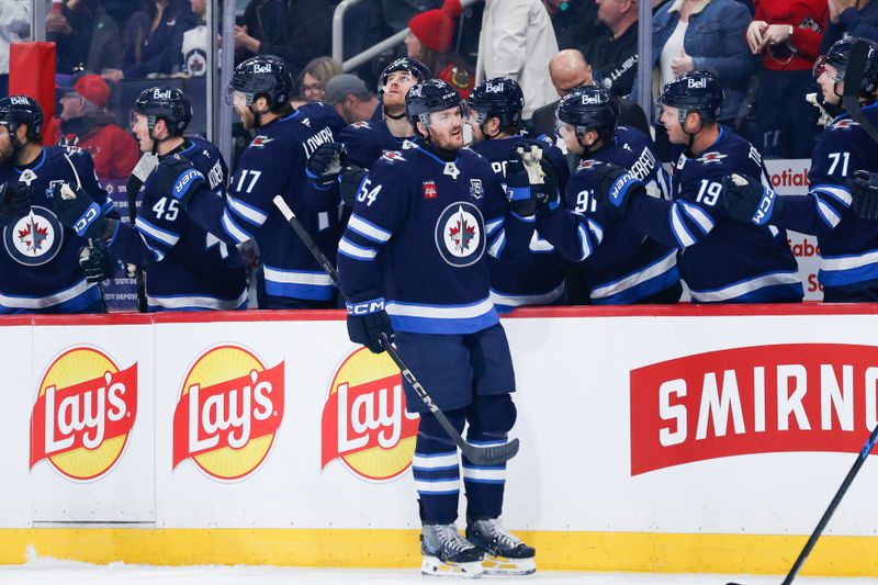 Mar 3, 2026; Winnipeg, Manitoba, CAN;  Winnipeg Jets defenseman Dylan Samberg (54) is congratulated by teammates after a goal against the Chicago Blackhawks during the first period at Canada Life Centre. Mandatory Credit: Terrence Lee-Imagn Images