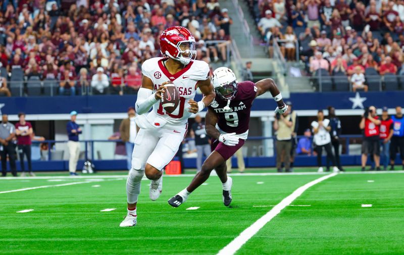 Sep 28, 2024; Arlington, Texas, USA;  Arkansas Razorbacks quarterback Taylen Green (10) tries to avoid the rush of Texas A&M Aggies defensive back Trey Jones III (9) during the first half at AT&T Stadium. Mandatory Credit: Kevin Jairaj-Imagn Images