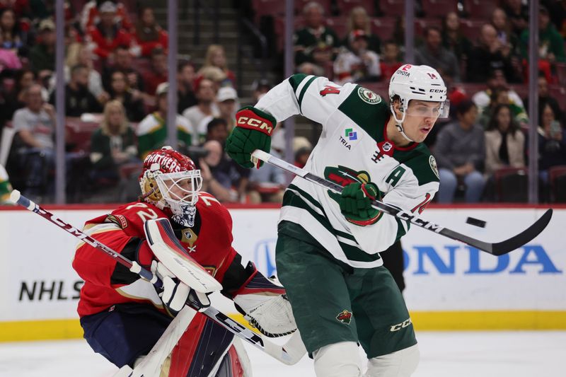 Jan 19, 2024; Sunrise, Florida, USA; Minnesota Wild center Joel Eriksson Ek (14) attempts to deflect the puck against Florida Panthers goaltender Sergei Bobrovsky (72) during the first period at Amerant Bank Arena. Mandatory Credit: Sam Navarro-USA TODAY Sports