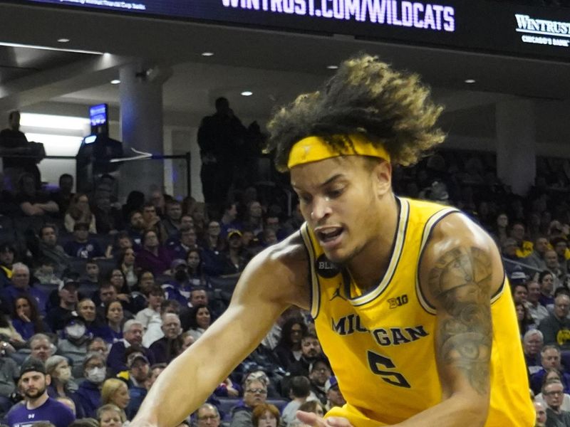 Feb 2, 2023; Evanston, Illinois, USA; Michigan Wolverines forward Terrance Williams II (5) grabs a loose ball against the Northwestern Wildcats during the second half at Welsh-Ryan Arena. Mandatory Credit: David Banks-USA TODAY Sports