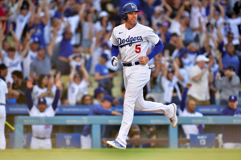 Jun 25, 2023; Los Angeles, California, USA; Los Angeles Dodgers first baseman Freddie Freeman (5) runs home to score against the Houston Astros during the eighth inning at Dodger Stadium. Mandatory Credit: Gary A. Vasquez-USA TODAY Sports