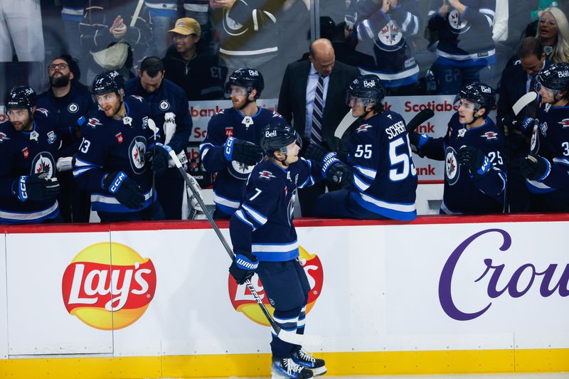 Oct 30, 2025; Winnipeg, Manitoba, CAN;  Winnipeg Jets forward Vladislav Namestnikov (7) is congratulated by team mates for scoring against Chicago Blackhawks goalie Spencer Knight (30) during the first period at Canada Life Centre. Mandatory Credit: Terrence Lee-Imagn Images