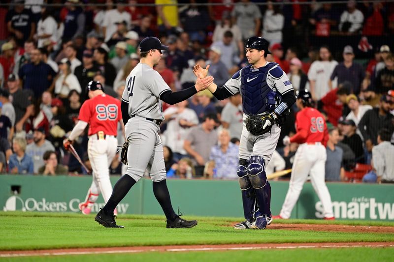 Sep 14, 2023; Boston, Massachusetts, USA; New York Yankees relief pitcher Tommy Kahnle (41) and catcher Kyle Higashioka (66) celebrate defeating the Boston Red Sox at Fenway Park. Mandatory Credit: Eric Canha-USA TODAY Sports