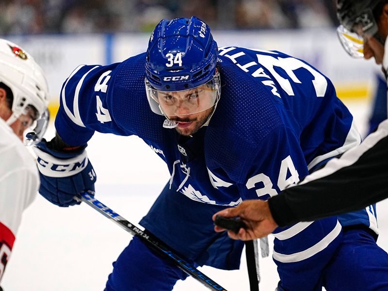 Sep 24, 2022; Toronto, Ontario, CAN; Toronto Maple Leafs forward Auston Matthews (34) keeps his eye on the puck before a face off against the Ottawa Senators during the second period at Scotiabank Arena. Mandatory Credit: John E. Sokolowski-USA TODAY Sports