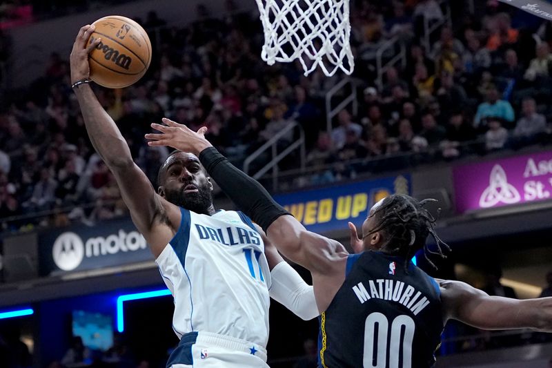 INDIANAPOLIS, INDIANA - MARCH 27: Tim Hardaway Jr. #11 of the Dallas Mavericks attempts a layup while being guarded by Bennedict Mathurin #00 of the Indiana Pacers in the second quarter at Gainbridge Fieldhouse on March 27, 2023 in Indianapolis, Indiana. NOTE TO USER: User expressly acknowledges and agrees that, by downloading and or using this photograph, User is consenting to the terms and conditions of the Getty Images License Agreement. (Photo by Dylan Buell/Getty Images)