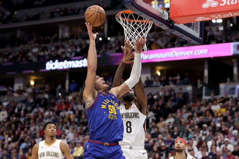 DENVER, COLORADO - JANUARY 12: Aaron Gordon #50 of the Denver Nuggets throws up a shot against Naji Marshall #8 of the New Orleans Pelicans in the first quarter at Ball Arena on January 12, 2024 in Denver, Colorado. NOTE TO USER: User expressly acknowledges and agrees that, by downloading and or using this photograph, User is consenting to the terms and conditions of the Getty Images License Agreement.  (Photo by Matthew Stockman/Getty Images)