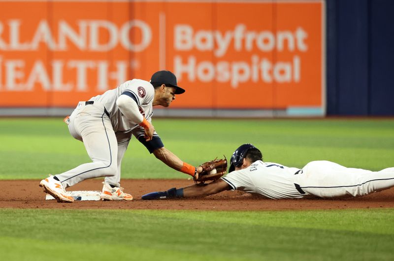 Aug 14, 2024; St. Petersburg, Florida, USA;Houston Astros shortstop Jeremy Pena (3) tags out Tampa Bay Rays shortstop Jose Caballero (7) during the eight inning at Tropicana Field. Mandatory Credit: Kim Klement Neitzel-USA TODAY Sports