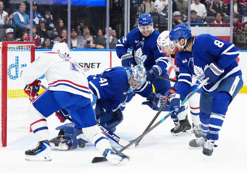 Oct 8, 2025; Toronto, Ontario, CAN; Montreal Canadiens right wing Cole Caufield (13) battles for the puck in front of Toronto Maple Leafs goaltender Anthony Stolarz (41) during the second period at Scotiabank Arena. Mandatory Credit: Nick Turchiaro-Imagn Images