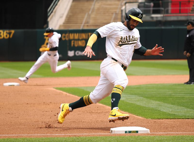 May 25, 2024; Oakland, California, USA; Oakland Athletics third baseman Abraham Toro (31) rounds third base ahead of Oakland Athletics center fielder JJ Bleday (33) as they are both batted in against the Houston Astros during the first inning at Oakland-Alameda County Coliseum. Mandatory Credit: Kelley L Cox-USA TODAY Sports