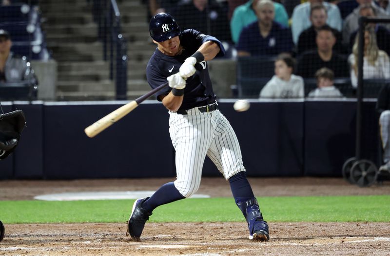 Mar 3, 2025; Tampa, Florida, USA; New York Yankees shortstop Anthony Volpe (11) singles during the second inning against the Pittsburgh Pirates  at George M. Steinbrenner Field. Mandatory Credit: Kim Klement Neitzel-Imagn Images