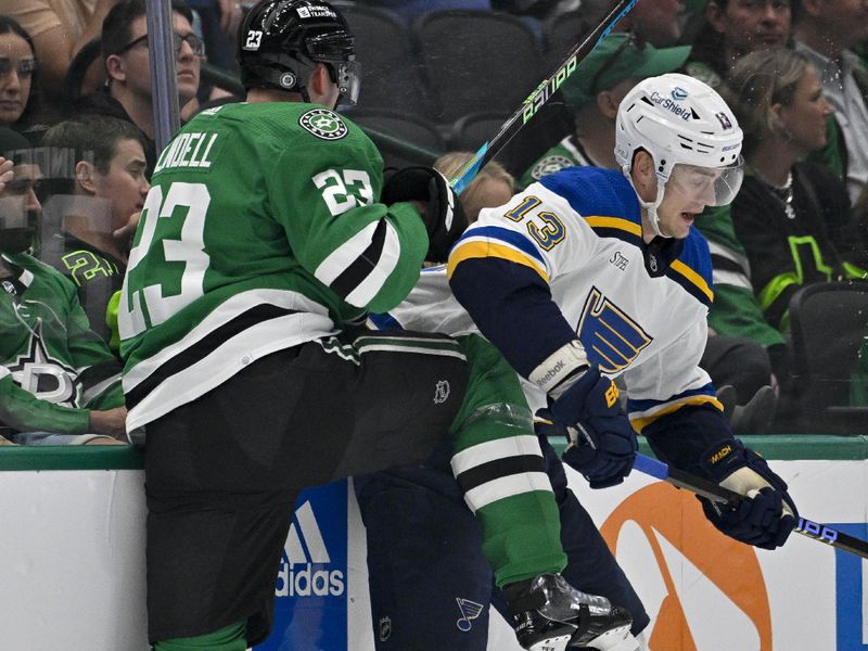 Apr 17, 2024; Dallas, Texas, USA; Dallas Stars defenseman Esa Lindell (23) checks St. Louis Blues right wing Alexey Toropchenko (13) during the first period at the American Airlines Center. Mandatory Credit: Jerome Miron-USA TODAY Sports