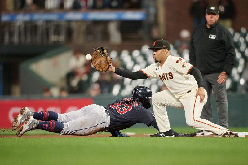 Sep 11, 2023; San Francisco, California, USA; San Francisco Giants infielder LaMonte Wade Jr. (31) commits a fielding error on a pickup throw against Cleveland Guardians catcher Bo Naylor (23) as umpire Bruce Dreckman (1) watches the play during the fourth inning at Oracle Park. Mandatory Credit: Robert Edwards-USA TODAY Sports