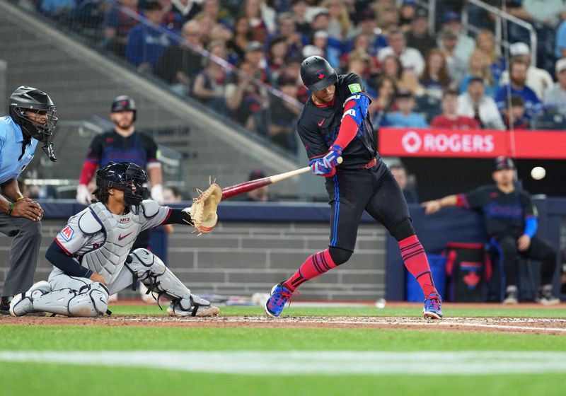 May 2, 2025; Toronto, Ontario, CAN; Toronto Blue Jays designated hitter George Springer (4) hits a single on catcher interference call by the home plate umpire against the Cleveland Guardians during the third inning at Rogers Centre. Mandatory Credit: Nick Turchiaro-Imagn Images