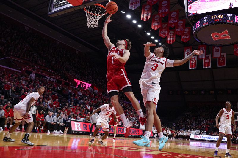Feb 7, 2026; Piscataway, New Jersey, USA; Nebraska Cornhuskers guard Sam Hoiberg (1) goes to the basket against Rutgers Scarlet Knights guard Kaden Powers (3) during the first half at Jersey Mike's Arena. Mandatory Credit: Vincent Carchietta-Imagn Images