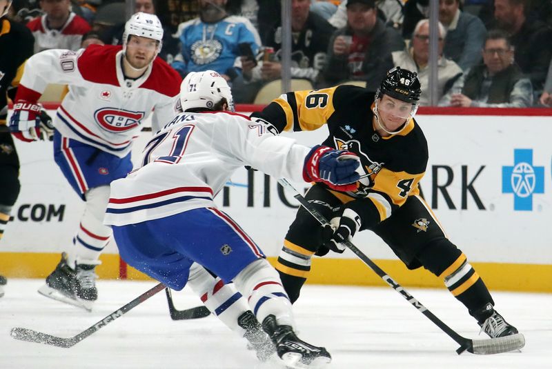 Nov 2, 2024; Pittsburgh, Pennsylvania, USA;  Pittsburgh Penguins center Blake Lizotte (46) moves the puck against Montreal Canadiens center Jake Evans (71) during the third period at PPG Paints Arena. Mandatory Credit: Charles LeClaire-Imagn Images