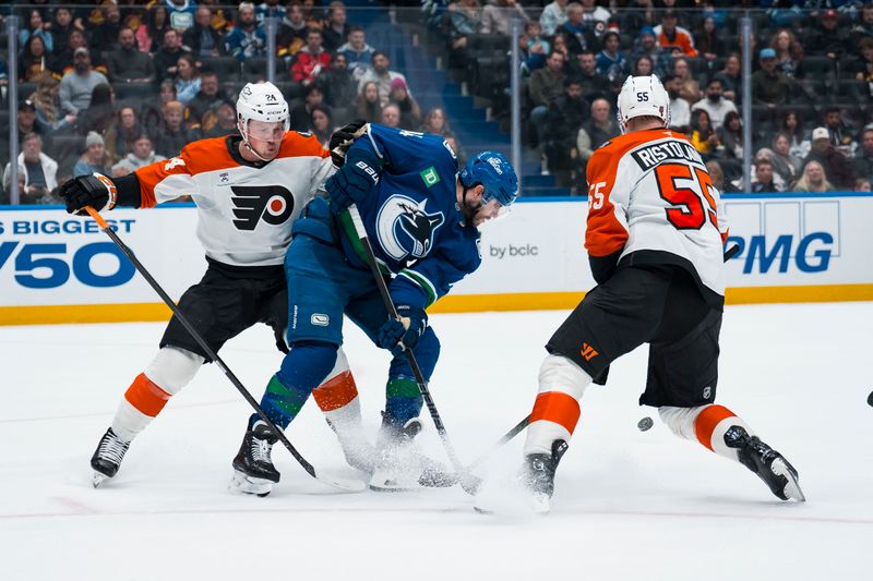 Dec 30, 2025; Vancouver, British Columbia, CAN; Philadelphia Flyers defenseman Nick Seeler (24) and defenseman Rasmus Ristolainen (55) check Vancouver Canucks forward Jake DeBrusk (74) in the second period at Rogers Arena. Mandatory Credit: Bob Frid-Imagn Images