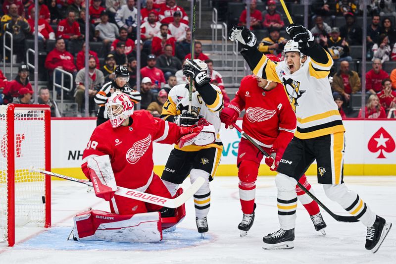 Oct 10, 2024; Detroit, Michigan, USA; Pittsburgh Penguins right wing Rickard Rakell (67) and center Sidney Crosby (87) celebrate the goal of defenseman Erik Karlsson (not pictured) as Detroit Red Wings goaltender Cam Talbot (39) tends the net during the third period at Little Caesars Arena. Mandatory Credit: Tim Fuller-Imagn Images