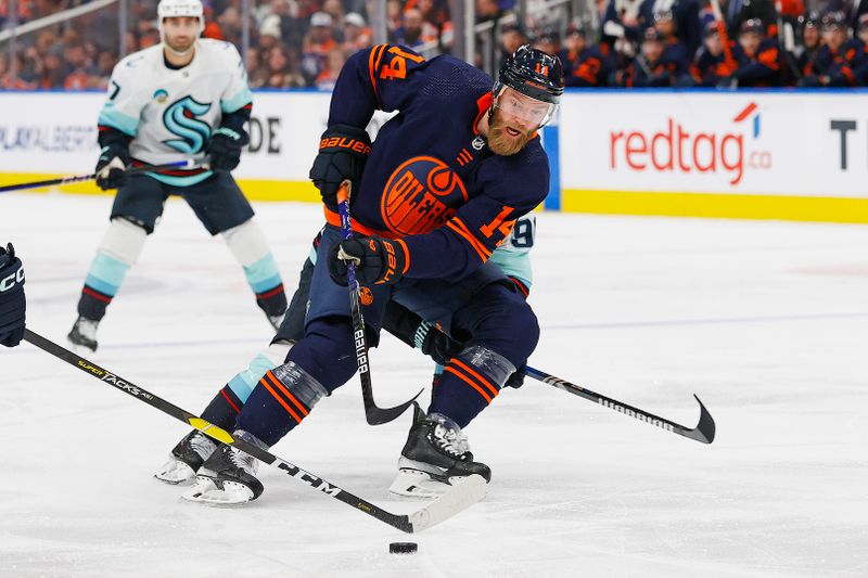 Jan 18, 2024; Edmonton, Alberta, CAN; Edmonton Oilers defensemen Mattias Ekholm (14) carries the puck around Seattle Kraken forward Tomas Tatar (90) during the third period at Rogers Place. Mandatory Credit: Perry Nelson-USA TODAY Sports