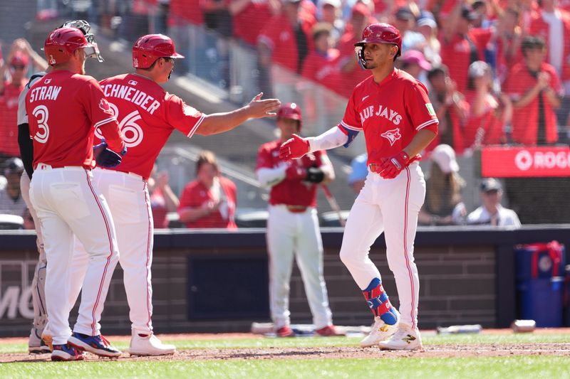 Jul 1, 2025; Toronto, Ontario, CAN; Toronto Blue Jays second baseman Andre Gimenez (0) hits a three run home run and celebrates with left fielder Davis Schneider (36) and centre fielder Myles Straw (3) against the New York Yankees during the fourth inning at Rogers Centre. Mandatory Credit: Nick Turchiaro-Imagn Images