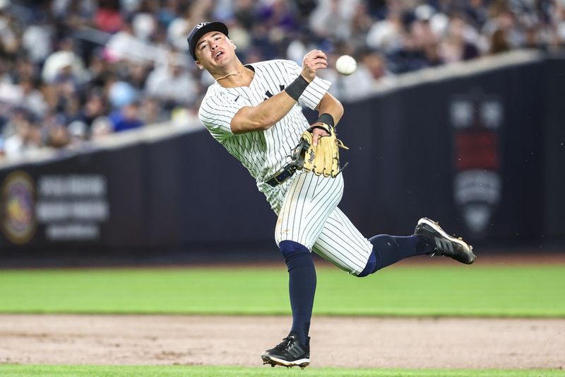 May 22, 2024; Bronx, New York, USA;  New York Yankees shortstop Anthony Volpe (11) throws to to first base for an assist in the sixth inning against the Seattle Mariners at Yankee Stadium. Mandatory Credit: Wendell Cruz-USA TODAY Sports