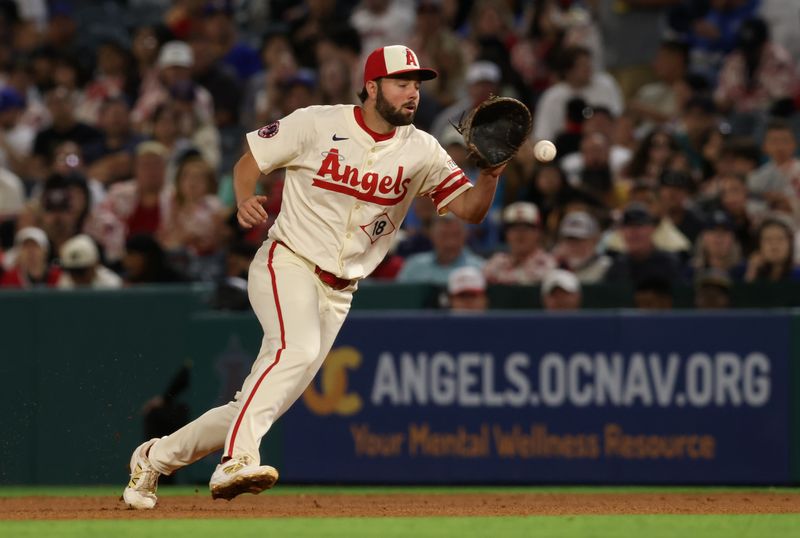 Jun 6, 2025; Anaheim, California, USA; Los Angeles Angels first baseman Nolan Schanuel (18) fields a grounder during the seventh inning against the Seattle Mariners at Angel Stadium. Mandatory Credit: Jason Parkhurst-Imagn Images