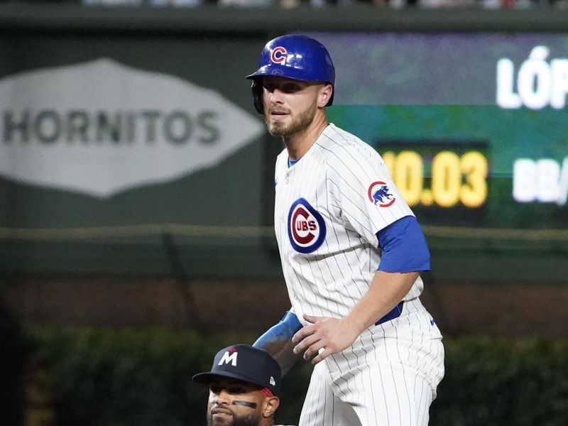 Aug 6, 2024; Chicago, Illinois, USA; Chicago Cubs first baseman Michael Busch (29) is safe at second base as Minnesota Twins shortstop Willi Castro (50) makes a late tag during the fifth inning at Wrigley Field. Mandatory Credit: David Banks-USA TODAY Sports