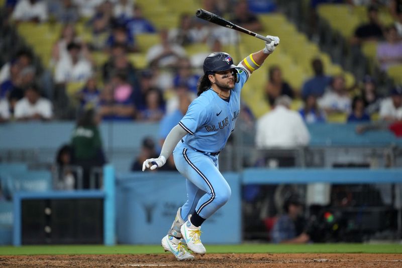 Jul 25, 2023; Los Angeles, California, USA; Toronto Blue Jays shortstop Bo Bichette (11) singles in the 10th inning against the Los Angeles Dodgers at Dodger Stadium. Mandatory Credit: Kirby Lee-USA TODAY Sports