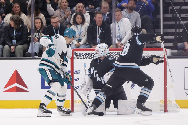 Oct 28, 2024; Salt Lake City, Utah, USA;  San Jose Sharks center Alexander Wennberg (21) scores past Utah Hockey Club goaltender Connor Ingram (39) during overtime at Delta Center. Mandatory Credit: Chris Nicoll-Imagn Images