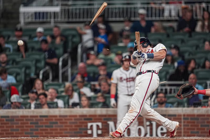 Sep 9, 2024; Cumberland, Georgia, USA; Atlanta Braves catcher Sean Murphy (12) splinters his bat while lining out against the Cincinnati Reds during the seventh inning at Truist Park. Mandatory Credit: Dale Zanine-Imagn Images