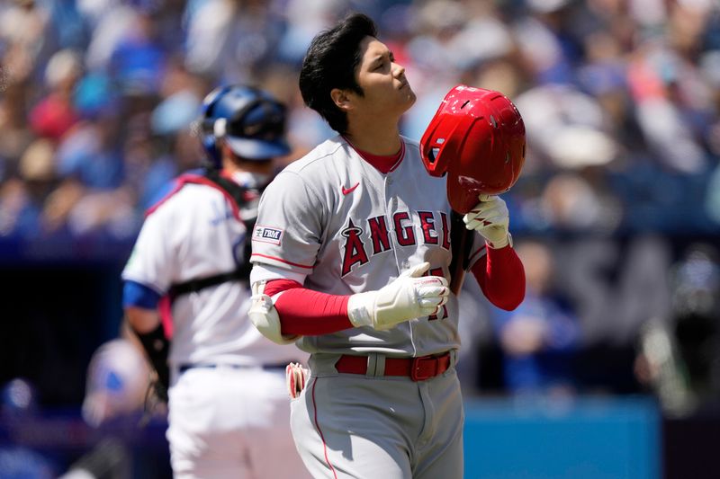 Jul 30, 2023; Toronto, Ontario, CAN; Los Angeles Angels designated hitter Shohei Ohtani (17) removes his helmet during an at bat against the Toronto Blue Jays in the first inning at Rogers Centre. Mandatory Credit: John E. Sokolowski-USA TODAY Sports