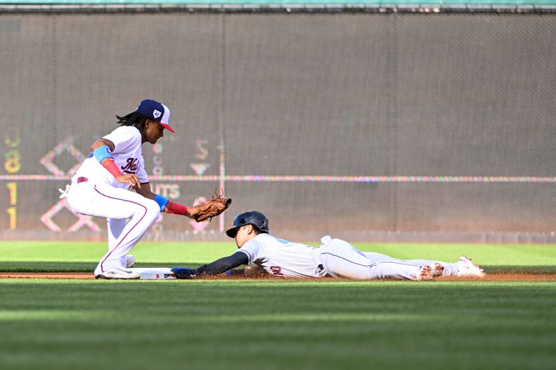 Apr 15, 2023; Washington, District of Columbia, USA; Cleveland Guardians left fielder Steven Kwan (38) steals second base under the tag attempt of Washington Nationals shortstop CJ Abrams (5) during the first inning at Nationals Park. Mandatory Credit: Brad Mills-USA TODAY Sports