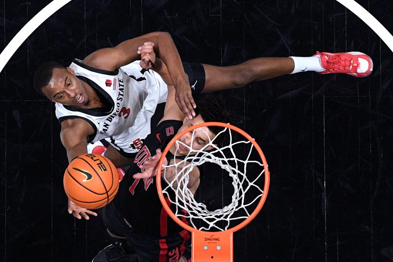 Jan 6, 2024; San Diego, California, USA; San Diego State Aztecs guard Micah Parrish (3) is fouled while going to the basket against UNLV Rebels forward Jalen Hill (1) during the first half at Viejas Arena. Mandatory Credit: Orlando Ramirez-USA TODAY Sports