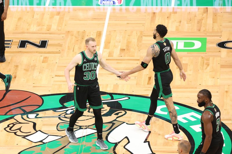 BOSTON, MA - JUNE 9: Sam Hauser #30 and Jayson Tatum #0 of the Boston Celtics high five during the game against the Dallas Mavericks during Game 2 of the 2024 NBA Finals on June 9, 2024 at the TD Garden in Boston, Massachusetts. NOTE TO USER: User expressly acknowledges and agrees that, by downloading and or using this photograph, User is consenting to the terms and conditions of the Getty Images License Agreement. Mandatory Copyright Notice: Copyright 2024 NBAE  (Photo by Joe Murphy/NBAE via Getty Images)