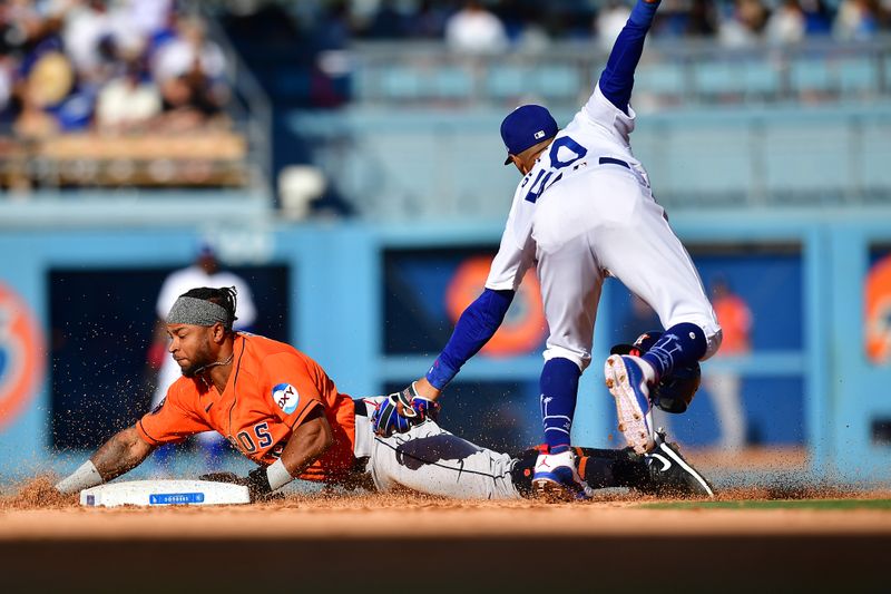 Jun 25, 2023; Los Angeles, California, USA; Houston Astros designated hitter Corey Julks (9) steals second against Los Angeles Dodgers second baseman Mookie Betts (50) during the seventh inning at Dodger Stadium. Mandatory Credit: Gary A. Vasquez-USA TODAY Sports